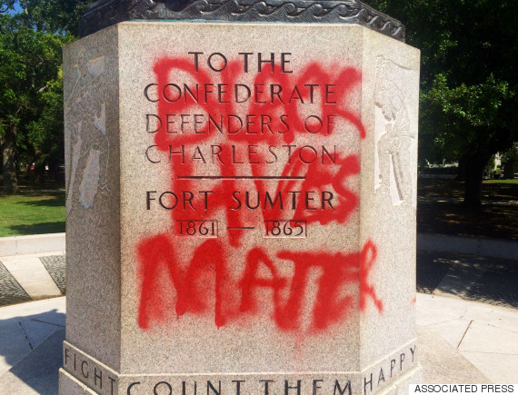 A statue memorializing the Confederacy is spray-painted with the message 